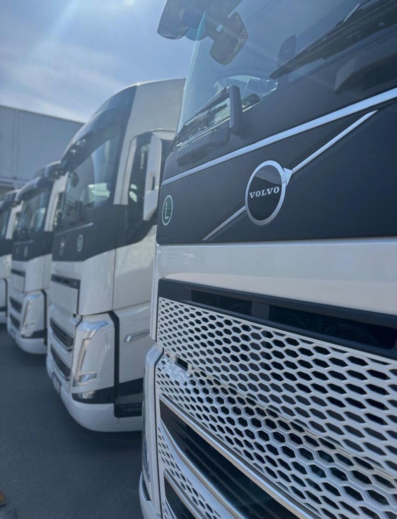 A row of white Volvo trucks