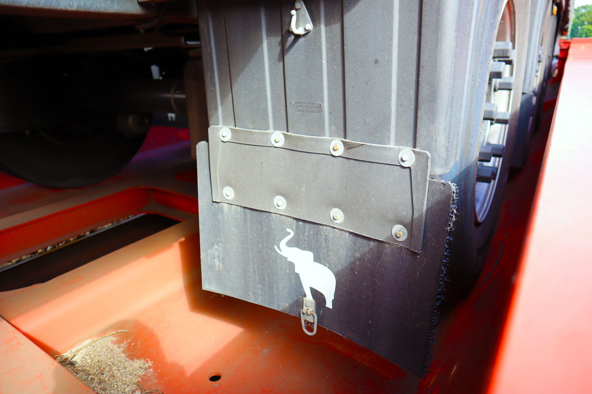 A CargoFlex trailer's wheel resting in a red rail pocket wagon